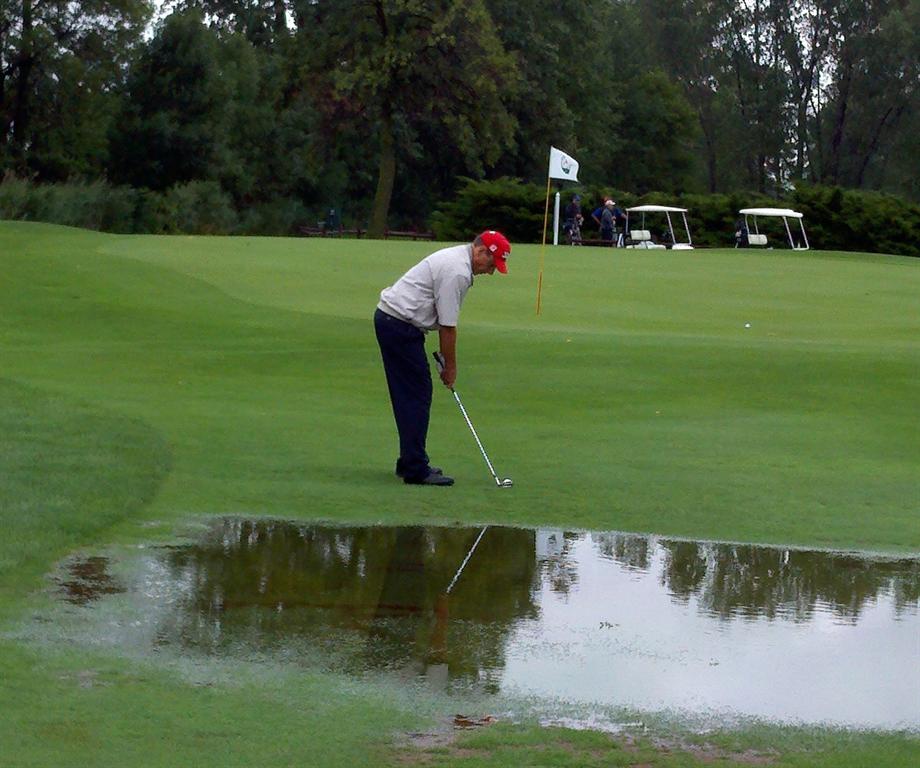 &nbsp; Chris Goulet chips up on #14 during the water soaked second round. 